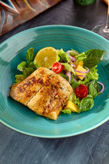 White Fish Steak with Fresh Vegetable Salad on a Turquoise Plate – Vibrant Food Photography