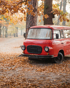 Red classic Barkas B1000 van in autumn forest. Front end three quarter view of East German minibus. Kyiv region, Ukraine - October 20 2019.