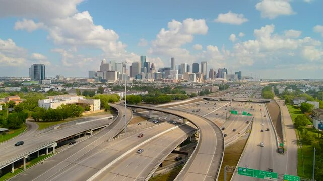 Parallax Drone shot Interstate Texas highway 288 Downtown Houston Texas. Daylight Intro aerial shot Houston Downtown. Aerial highway 288 and interstate 69 intersection overlooking downtown Houston