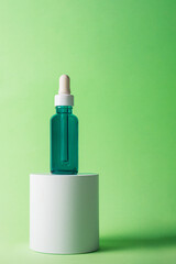 Blue sunscreen bottle on green background. Sunscreen concept. Skin care concept. Copy space.