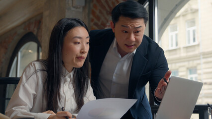 Asian Korean business Chinese man businessman male boss leader talk angry dissatisfied scold papers documents data diagram mistake laptop office Japanese intern woman girl businesswoman bad working