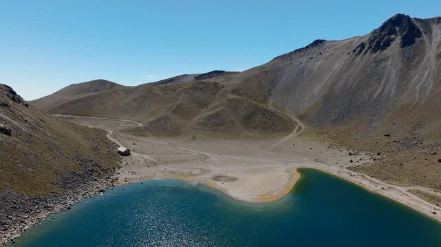 Laguna del Sol in Nevado de Toluca volcano crater, Mexico. Pan left overlooking high peaks, treks and travel paths