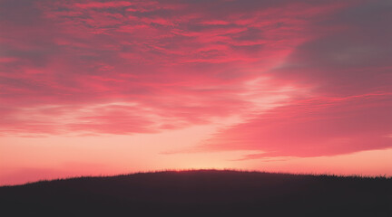 Fototapeta premium silhouette of a hill against a gradient sky that transitions from soft pink to deep orange
