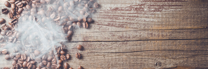 Overhead shot of coffee beans on an old wooden table