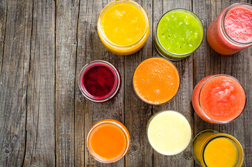 Glasses of fresh juice on an old wooden table