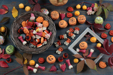Wooden Halloween candy board. Holidays and Food. Dessert in shape of pumpkin, skull, witch. 