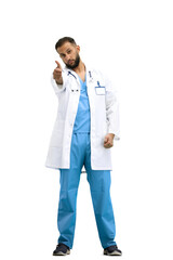 The doctor, in full height, on a white background, shows his thumbs up