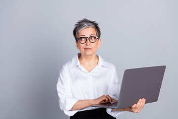 Photo portrait of lovely senior lady look empty space hold netbook dressed stylish formalwear...