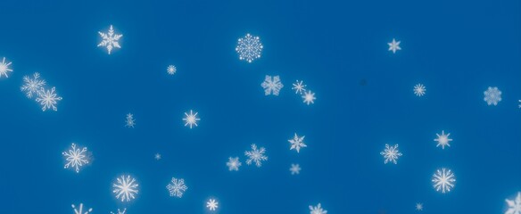 Winter Wonderland: Snowflakes Falling on Blue Sky