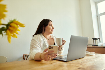 A plus size woman relaxes with coffee and her smartphone in a sunlit room.