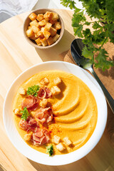Pumpkin soup with jamon and croutons
