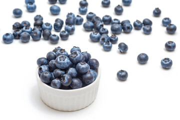 Fresh blueberries in a bowl on white background. Wild berries. Healthy eating