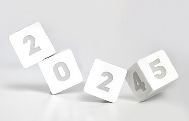 White cube block flipping from 2024 to 2025 on white background