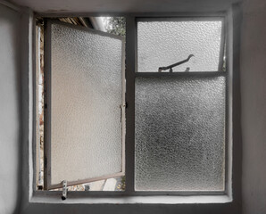 Old vintage frosted privacy glass windows in a bathroom