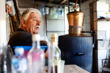 Elderly Man in Workshop with Distillery Equipment