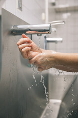 Unrecognizable person washing hands