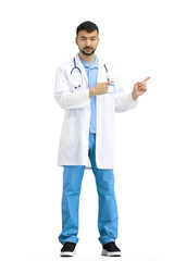 The doctor, in full height, on a white background, points to the side