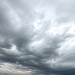 Obraz premium An intense sky with swirling clouds in shades of gray and blue, as strong winds push the clouds across the horizon, creating dramatic shapes 