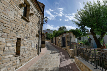 A small street among the old houses of a Guardia Perticara, small town in Basilicata, Italy.