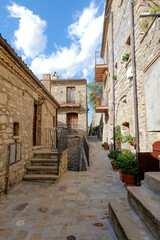 A small street among the old houses of a Guardia Perticara, small town in Basilicata, Italy.
