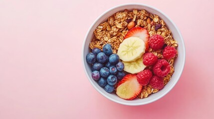 Simple top view of a muesli bowl with fresh fruit, featuring blank space for a clean composition.