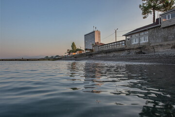 a tall multi-storey hotel on the sea beach.