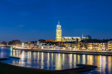Fototapeta premium Evening view of the Dutch city of Deventer in Overijssel with the river IJssel in front