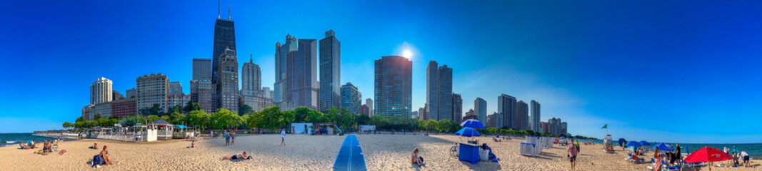 Chicago, IL - July 25, 2024: Tourists and locals relax at Oak Street Beach on a beautiful summer...