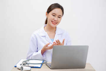 Asian female doctor sitting at desk working.