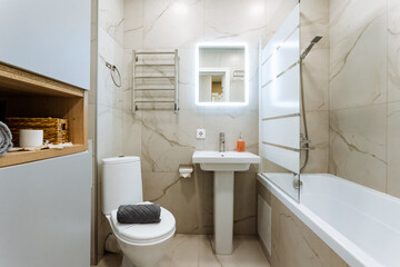 Discover a contemporary bathroom that showcases a chic shower and a comfortable bathtub,...