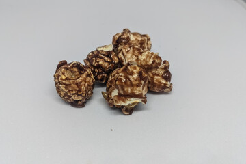 Chocolate popcorn on a white isolated background. toning. selective focus, copy space and clipping path