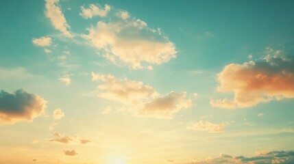 Obraz premium Golden-tinged Clouds in a Pale Blue Sky at Sunset