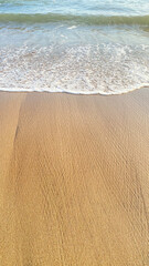 small beach waves on clean sand