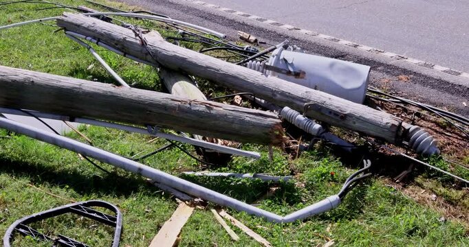 Several broken power lines lie crashed wires on ground following storm hurricane