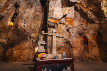 Buddhist statue inside the Asian sacred temple in the Am Phu Cave in the Marble Mountains in Da...