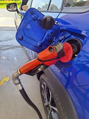 Fuel dispenser nozzle fills the car's tank with fuel