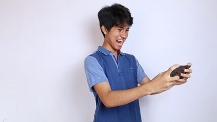 upset losing asian young man playing game on smartphone