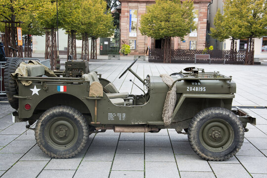 Hunningue - France - 5 October 2024 - profile view of green military jeep parked in the street