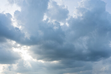 Fluffy cumulus clouds drift against a vibrant blue sky