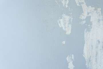 Aged grunge wall with textured blue paint, perfect for vintage design or art backdrop