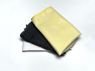 A stack of  high-quality microfiber cloths cleaning cloths isolated on white background. The clothes are folded neatly and appear to be clean and soft.