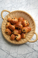 Basket with fresh baked croissant, top view