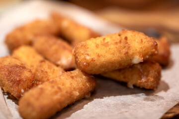 Close up of appetizing fried mozzarella sticks on paper towel