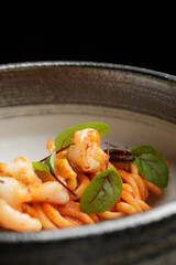 Pasta and tiger prawns in tomato sauce. Italian pasta with shrimps