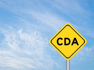 Yellow transportation sign with word CDA (Abbreviation of Confidential disclosure agreement) on blue color sky background