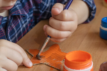 child draws with paints. children's hands close up