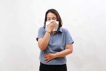 Portrait of beautiful young asian sick woman being wrapped in scarf sneezing, suffering from runny nose and high temperature. Cold and fever concept.