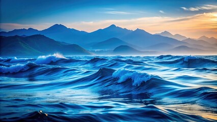 A serene backdrop featuring blue waves and soft mountain silhouettes, illustrating the tranquil beauty of an ocean water surface meeting rolling hills in harmony.