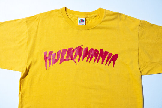 Kent, uk 01.01.2024 hulk hogan hulkamania yellow vintage tshirt fruit of the loom. Hulk wrestling unites states of America Americana merchandise. Fruit of the loom yellow t-shirt double stitch.