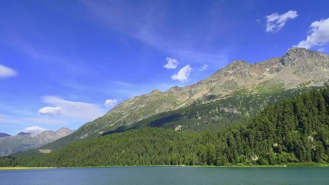 Beautiful Panoramic View over Lake Champf&egrave;r and Swiss Alps with Blue Sky and Clouds in a Sunny Summer Day in Silvaplana, Maloja, Grisons, Switzerland.